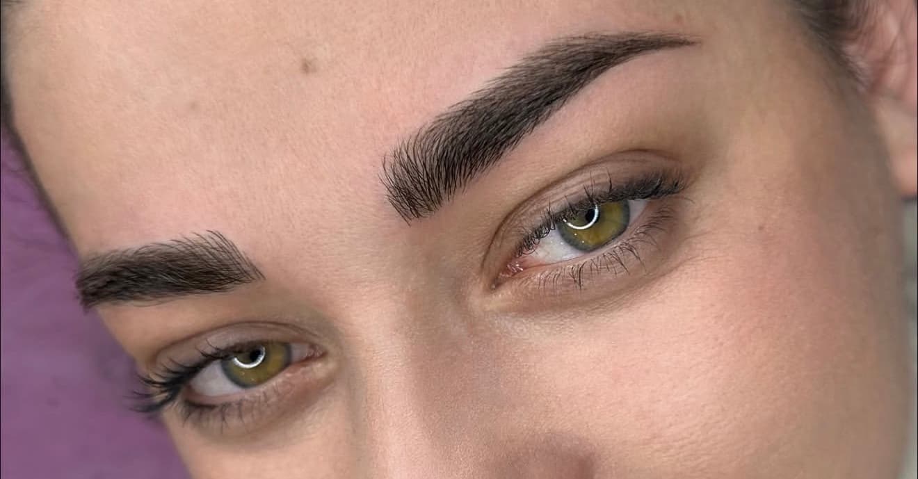 Both brows in one frame after a permanent makeup treatment, photographed close up.